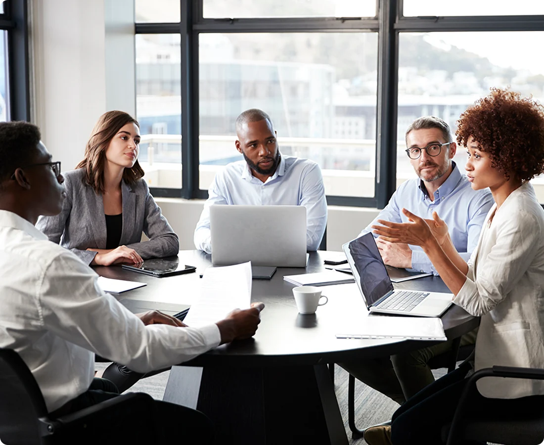 A room of people discuss a business-related problem.